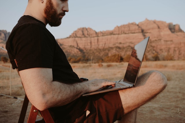 Photo by Dziana Hasanbekava: https://www.pexels.com/photo/thoughtful-man-with-laptop-in-countryside-5589356/